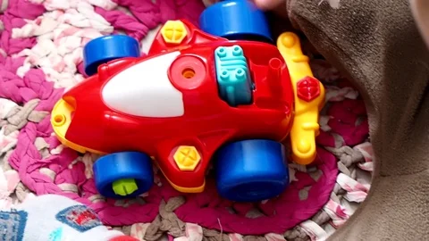 The child is playing with an educational toy. machine that can be completely Stock Footage 94328289