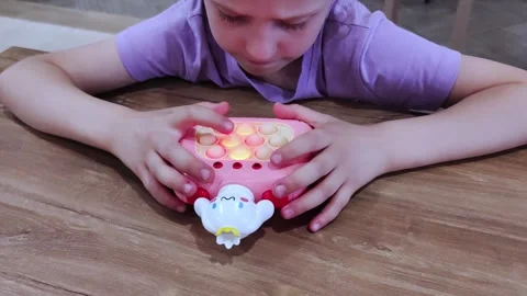 A child is playing with an electronic toy. Close up on electronic pop it fidget. Stock Footage 279621944