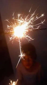 A child playing with fireworks Stock Photos