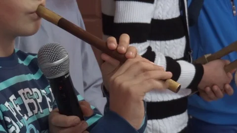 Child playing the flute during a performance for his fellow Stock Footage 95736723