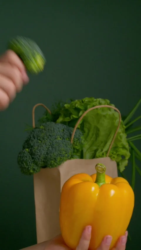 Child playing with fresh yellow pepper and broccoli on eco background Stock Footage 306259491