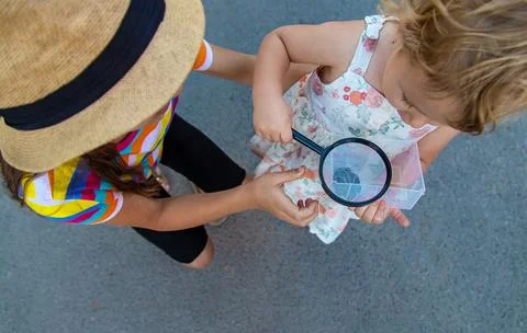 The child is playing with the frog. Selective focus. Stock Photos