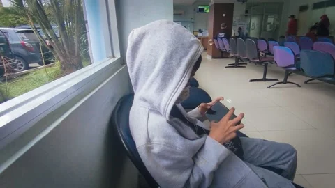 A Child Is Playing Gadgets While Waiting In Queue Stock Footage 236205152