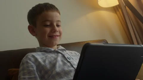 Child playing game on tablet or kid boy computer learning to wow excited and fun Stock-Footage 307735044
