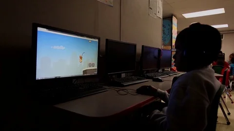 Child playing games on computer at South Texas Residential Family Centre Stock Footage 93544680