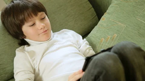 Child playing  games using tablet computer at home Stock Footage 45978879