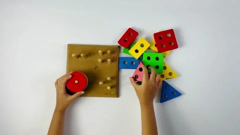 Child Playing with Geometric Shape Sorter Toy Top View Stock Footage 329735501