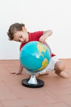 Child playing with a globe Stock Photos