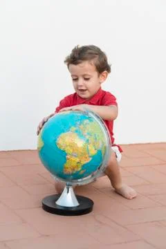Child playing with a globe Stock Photos