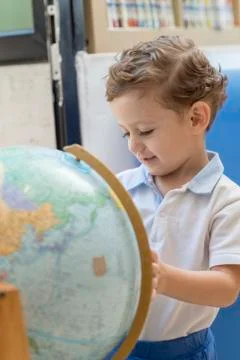 Child playing with a globe Stock Photos