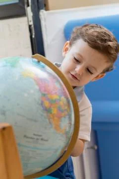 Child playing with a globe Stock Photos