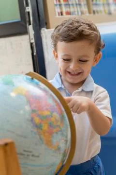 Child playing with a globe Stock Photos