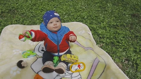 The child is playing on the green grass Video stock 75337565