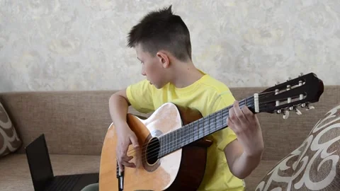 Child playing guitar Stock Footage 152802868