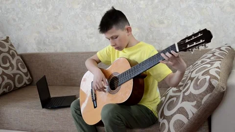Child playing guitar Stock Footage 152803140