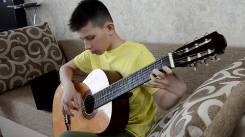 Child playing guitar Stock Footage 152803185