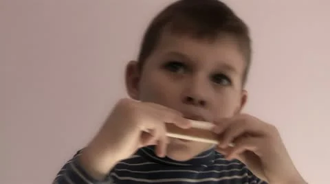 Child playing harmonica Stock Footage 12227628