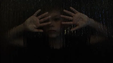 Child playing hide and seek behind frosted glass Stock Footage 49996232