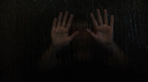 Child playing hide and seek behind frosted glass Stock Footage 49996342