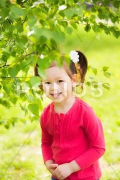 Child playing hide and seek outdoors in park Stock Photos