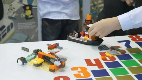 Child playing intellectual game with the designer Stock Footage 77656832