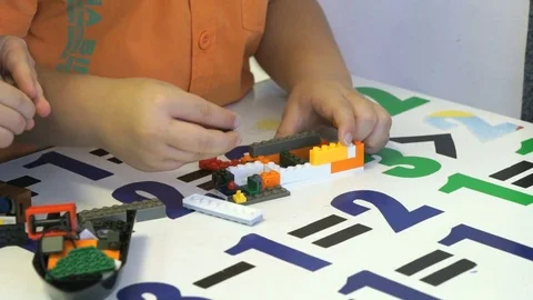 Child playing intellectual game with the designer Stock Footage 77656866