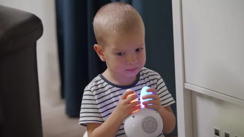 Child playing with interactive musical toy smart bunny sitting on a potty Stock Footage 258829003