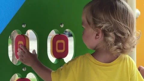 Child playing with interactive play wall Stock Footage 311673337