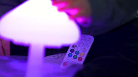 Child Playing with LED Lamp Remote and Touching Light Video stock 325131243