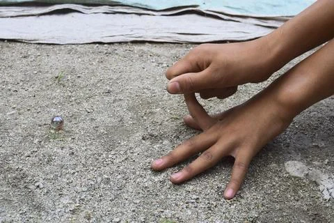 A child playing marbles Stock Photos
