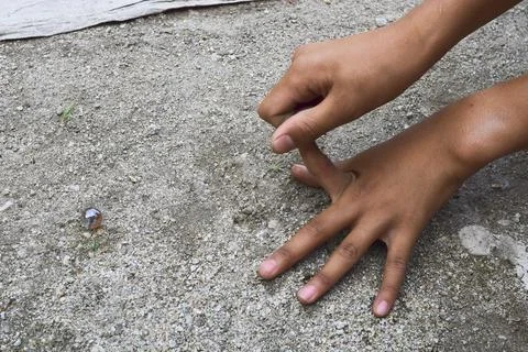 A child playing marbles Stock Photos