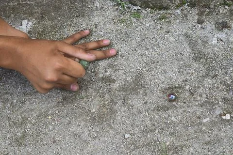 A child playing marbles Stock Photos