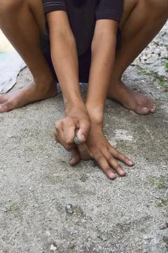 A child playing marbles Stock Photos