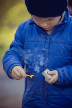 Child playing with matches Stock Photos