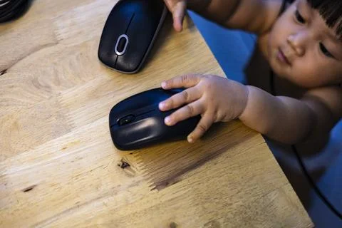 Child Is Playing With The Mouse Stock Photos