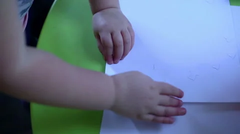 Child is playing with paper  Stock Footage 61925647