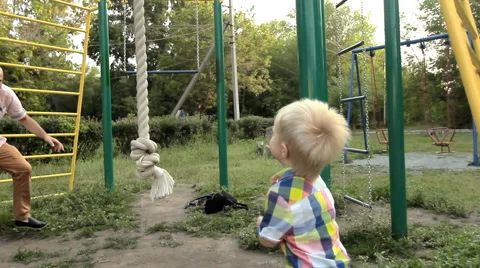 Child playing in the park on the playground Stock Footage 65319976