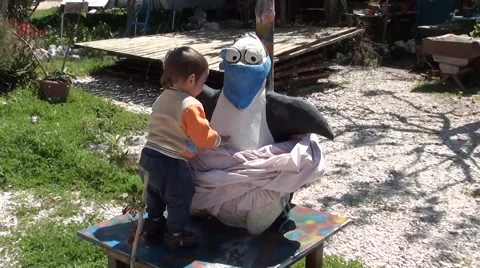 Child playing with penguin figure 2 Vídeos de archivo 49054667