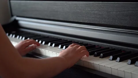 Child Playing Piano. Close up Side View Of A Child Playing Piano. Stock Footage 135946058
