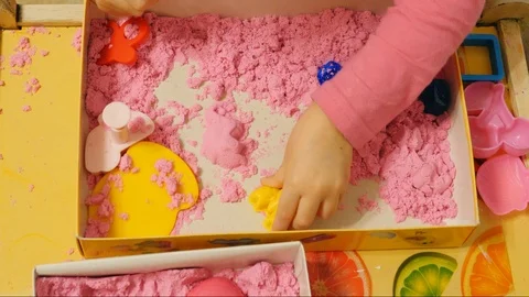 Child playing with pink play sand/magic sand Stock Footage 86291672