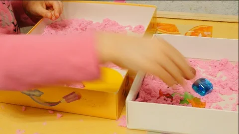 Child playing with pink play sand/magic sand Stock Footage 86292286