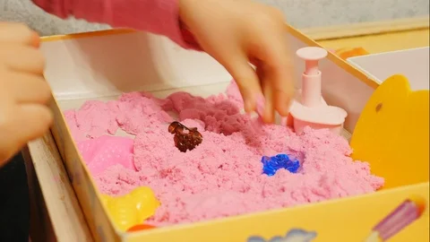 Child playing with pink play sand/magic sand Stock Footage 86293574
