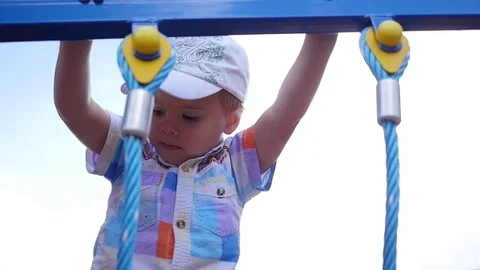 Child playing on the playground, coming up the stairs. Active outdoor sports Stock Footage