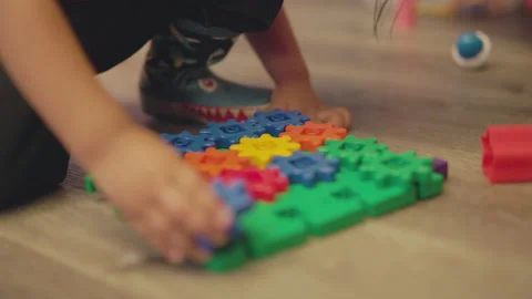 Child playing with puzzle on the floor Video stock 166163229