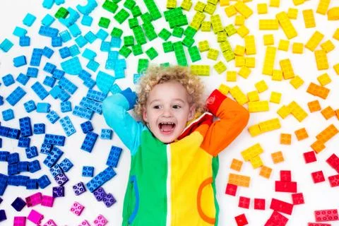 Child playing with rainbow plastic blocks toy Stock Photos
