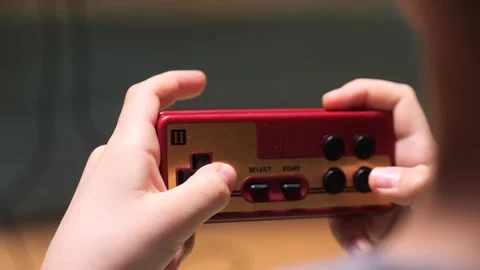 Child playing with retro gamepad controller Video stock 302659604