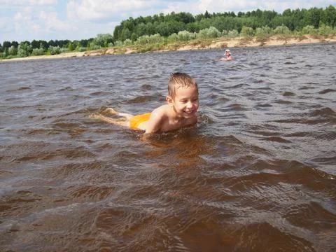 Child playing in the river Stock Photos