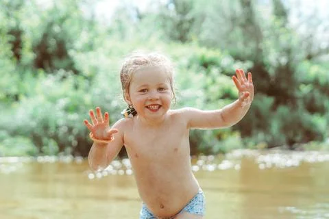 Child playing in the river Stock Photos