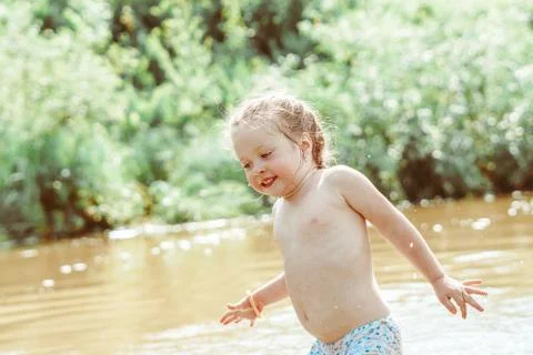 Child playing in the river Stock Photos
