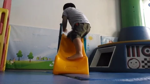 Child playing in the room slide. 動画素材 70790560